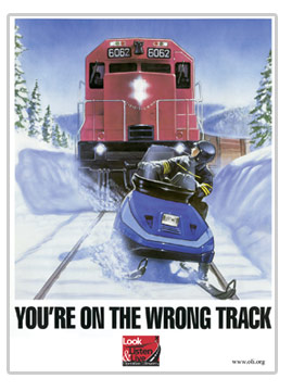 Snowmobile safety poster regarding crossing roads and railroad tracjs