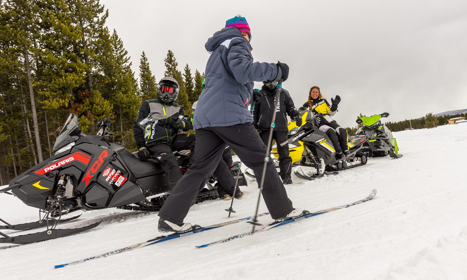 Snowmobilers encountering a cross-country skier