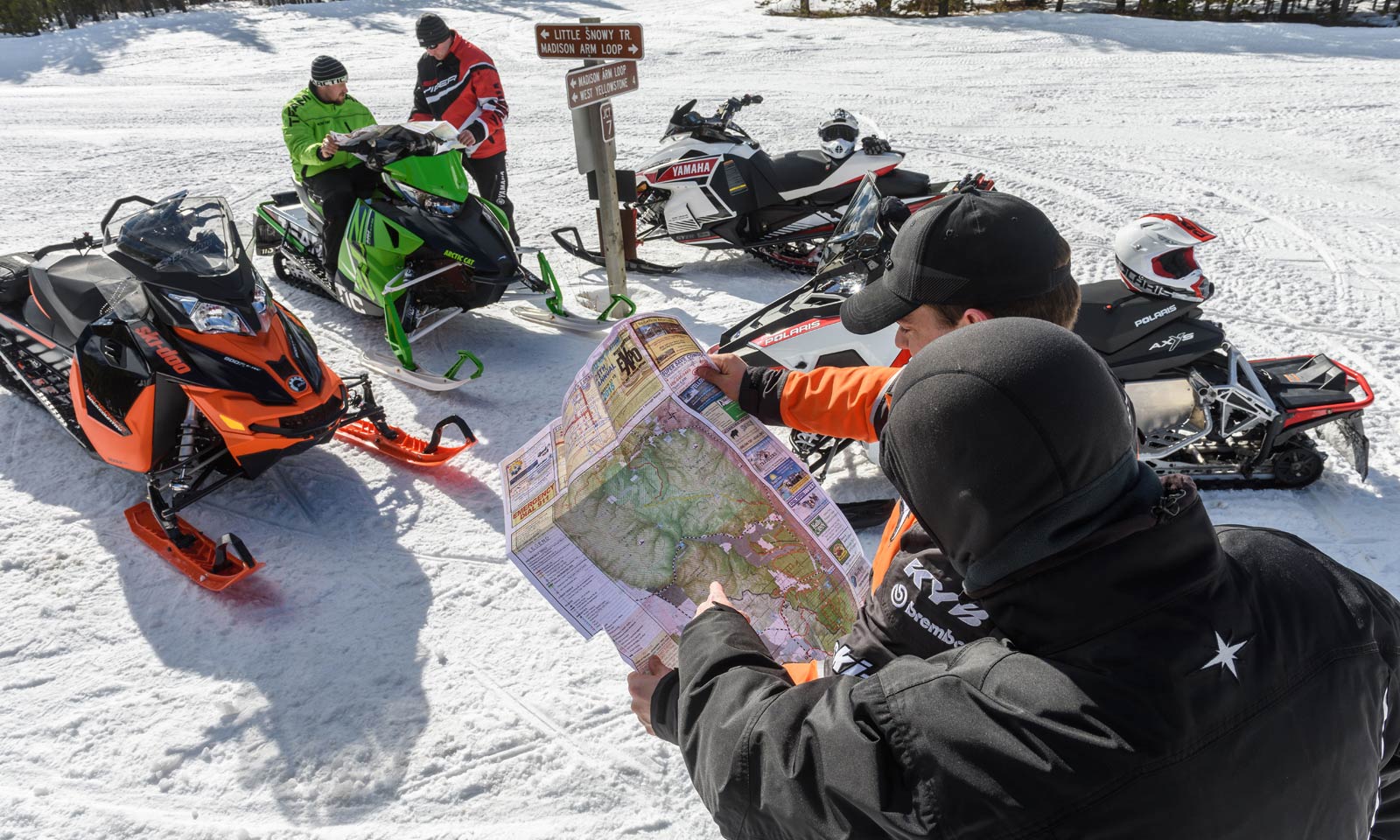 Snowmobilers looking at trail map